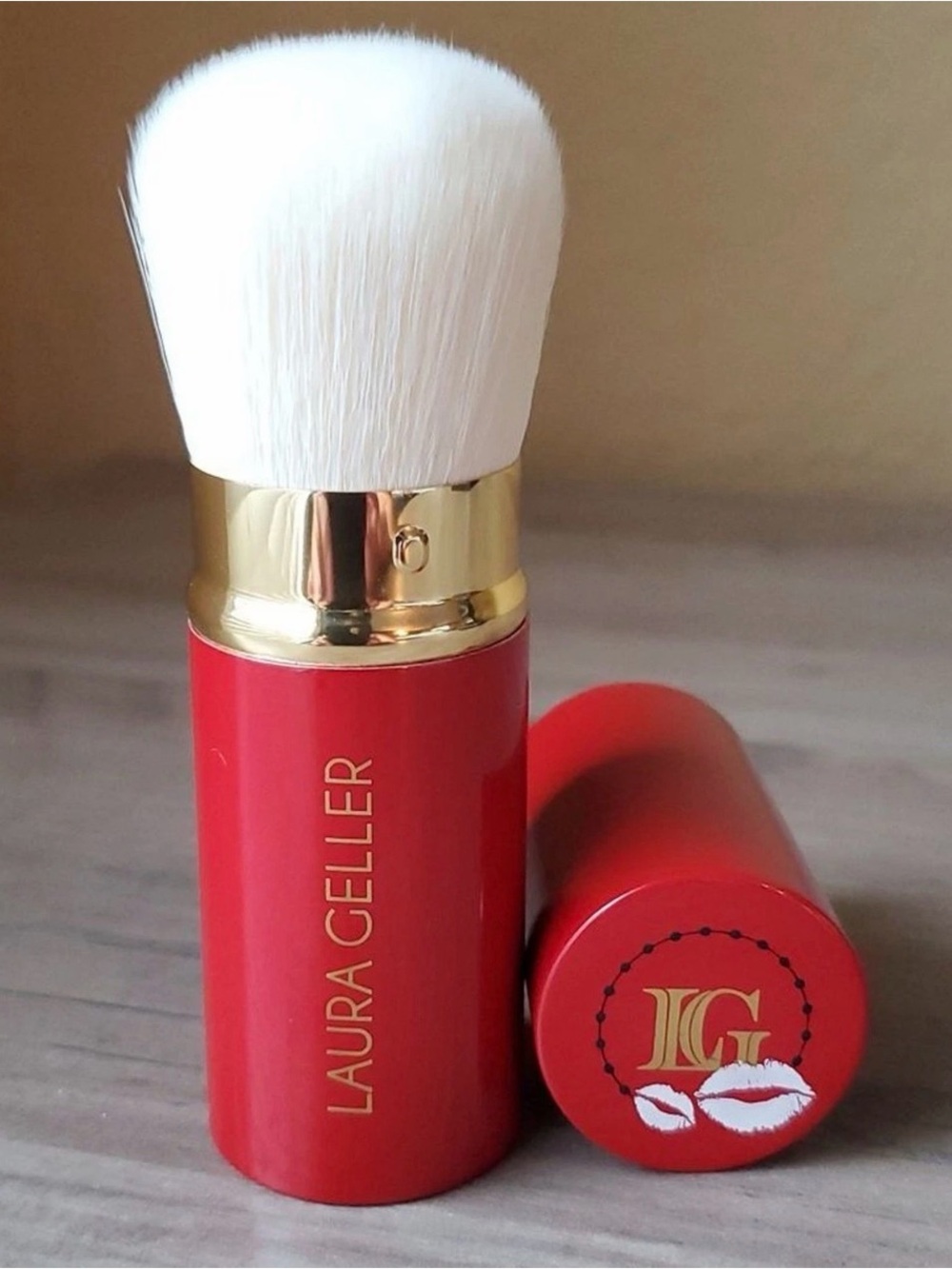 Laura Geller Red Retractable Kabuki Brush with White Bristles and Gold Ferrule